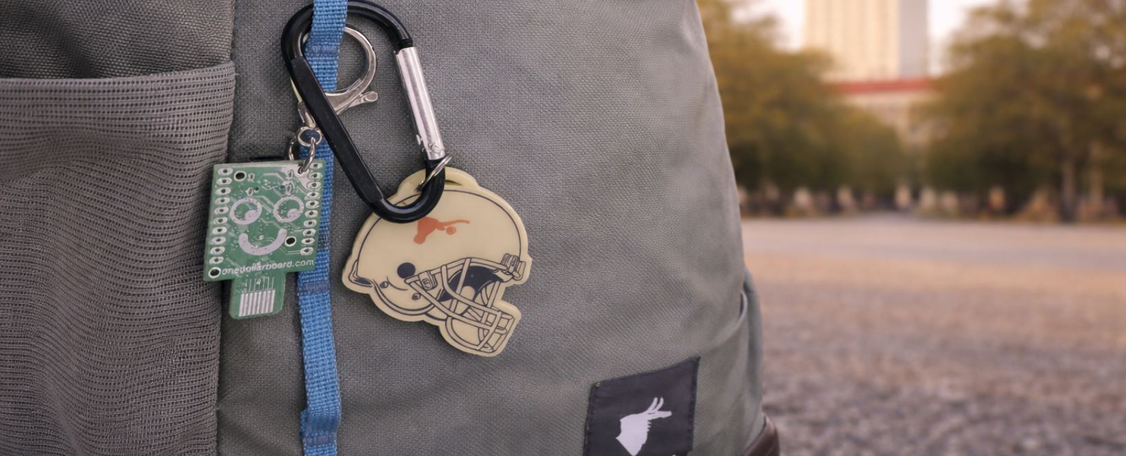 One Dollar Board — green PCB with a friendly face